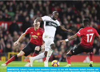  ??  ?? MANCHESTER: Fulham’s French striker Aboubakar Kamara (C) vies with Manchester United’s Brazilian midfielder Fred (R) during the English Premier League football match between Manchester United and Fulham at Old Trafford in Manchester, north west England yesterday. — AFP