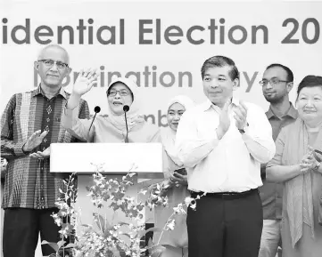  ?? — AFP photo ?? Halimah (second left) addresses supporters at the nomination centre in Singapore.