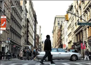  ?? The New York Times/CHRISTOPHE­R LEE ?? A pedestrian crosses Broadway in the SoHo neighborho­od of Manhattan last week.