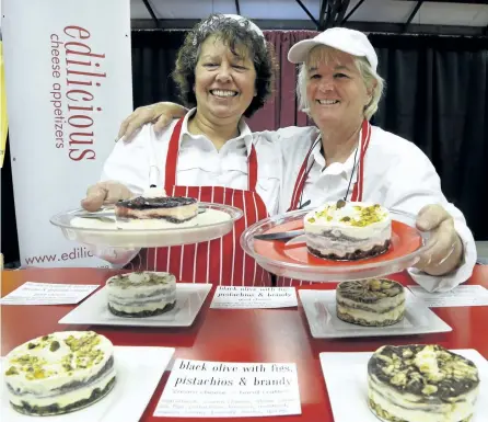  ?? CLIFFORD SKARSTEDT/EXAMINER ?? Jenny Hill, left, and owner Jen Smith of Edilicious display a pair of cheese appetizers during The Good Food and Wine Show showcasing Ontario's culinary community on Friday at the Morrow Building. Visitors indulged in pub fare, cultural cuisines, craft...