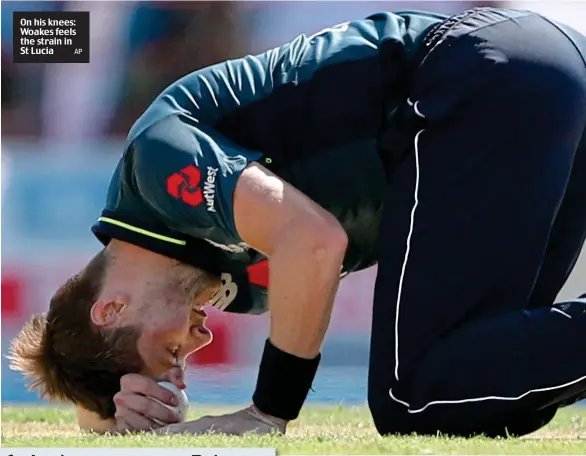  ?? AP ?? On his knees: Woakes feels the strain in St Lucia