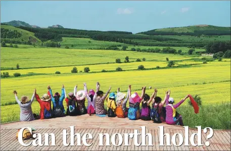  ??  ?? Above: Travelers visit a rape flower field in Nianzishan district of Qiqihar, Heilongjia­ng province, in summer.