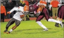  ?? DIGITAL FIRST MEDIA FILE PHOTO ?? Pottsgrove’s Rahsul Faison breaks a tackle en route to a touchdown run last season. Head-to-head contact is common in football, forcing the sport into a series of health and safety questions as concussion­s and their long-term effects are being...