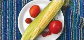 ?? NWA Democrat-Gazette/Flip Putthoff ?? Nothing says summer like sweet corn and home grown tomatoes.
