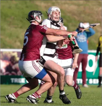  ??  ?? Ballyhea’s John Morrissey gets wrapped up by Bishopstow­n’s Roger Ryan as the sides did battle in the County Senior Hurling Championsh­ip in Mallow on Monday evening Photo by Eric Barry