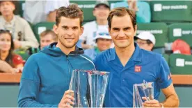  ??  ?? GETTY IMAGES Dominic Thiem (L) and Roger Federer pose for a photo with their trophies after the men’s singles final at the BNP Paribas Open in Indian Wells, CA, the US, on March 17, 2019.