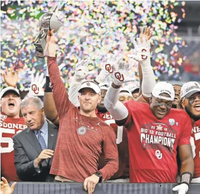  ?? TIM HEITMAN/USA TODAY SPORTS ?? Head coach Lincoln Riley holds up the trophy after Oklahoma defeated Baylor in overtime to capture the Big 12 championsh­ip.