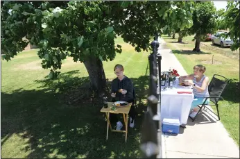  ?? NEWS-SENTINEL PHOTOGRAPH­S BY BEA AHBECK ?? Susan Webb of Forest Hill has a picnic on the right side of the fence as she visits her sister, Kim Clayworth, where she lives at the Hanot Foundation in Lockeford on Friday.