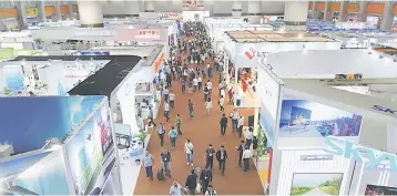  ??  ?? Visitors walk inside one of the exhibition halls for the China Import and Export Fair in Guangzhou, China April 17. Only one leader of a big Western country is attending China’s most important diplomatic event of the year, a summit next month on...