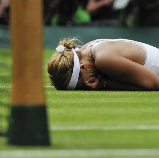  ?? CARL COURT / AFP / GETTY IMAGES ?? Sabine Lisicki lies on the court as she celebrates defeating Serena Williams in their fourth-round women’s singles match
at Wimbledon on Monday. Lisicki won 6-2, 1-6, 6-4 to eliminate the defending champion.