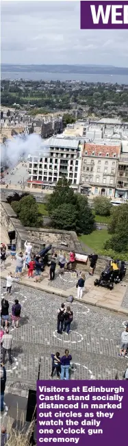  ??  ?? Visitors at Edinburgh Castle stand socially distanced in marked out circles as they watch the daily one o’clock gun ceremony