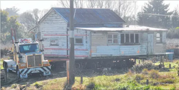  ?? PHOTO/CLINTON LLEWELLYN. ?? The so-called ‘murderer’s hut’ located just south of Waipawa Bridge — the scene of an axe attack in 1994 which left one person dead — on the back of a truck ready to be removed last week.