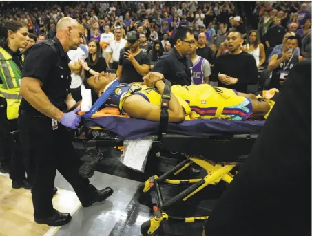  ?? Rich Pedroncell­i / Associated Press ?? Warriors guard Patrick McCaw is taken off the court on a stretcher after falling hard to the floor late in the third quarter .