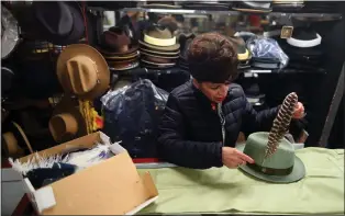  ?? PHOTOS BY ARIC CRABB — STAFF PHOTOGRAPH­ER ?? Ivette Velez dresses a hat with a feather while working at her family store Hammer and Lewis Clothiers on Feb. 14in San Jose. She says oldtimers are the shop's mainstay.