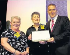  ??  ?? Going for gold Marie Bee and Anne Easson from Pride of Place are presented with the award from television presenter Iolo Williams