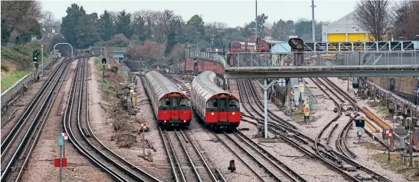  ?? ?? Piccadilly Line trains bound for Heathrow Airport (left) and Cockfoster­s (right) pass stabled ‘S’ stock outside Acton Town station on January 25. Simon (CC BY 2.0)