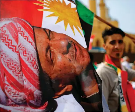  ??  ?? A Kurdish man in Martyrs Square in Beirut with a flag portraying Iraqi Kurdish leader Masoud Barzani at a gathering in support of next week’s referendum in Iraq on regional independen­ce for the Kurds