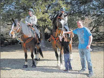  ?? Erik Verduzco Las Vegas Review-Journal @Erik_Verduzco ?? Ryan Greig, 7, with his father, Kevin, a TSA manager, pose with Metropolit­an Police Department mounted officers Mike Torsiello, left, and Maile Hanks, on Saturday at Sunset Park.