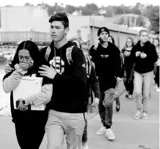  ?? AP ?? Students are escorted out of Saugus High School after reports of a shooting on Thursday, November 14, 2019, in Santa Clarita, Calif.