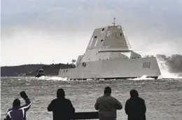  ?? ROBERT F. BUKATY AP FILE ?? Spectators watch the Zumwalt-class destroyer Lyndon B. Johnson travel down the Kennebec River on its way to sea Jan. 12, 2022, in Phippsburg, Maine.