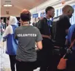  ?? JACQUELYN MARTIN, AP ?? Two of the Burundi members, at right in black shirts, attend the FIRST Global Robotics Challenge in Washington, D.C. The Burundi team is missing.