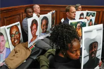  ?? Jacquelyn Martin/Associated Press ?? Family members of people who died in crashes of the Boeing 737 Max hold photograph­s of their lost loved ones as FAA administra­tor Stephen Dickson testifies Dec. 11 during a House Transporta­tion Committee hearing on Capitol Hill in Washington.