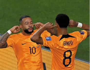  ?? — AFP ?? Enjoy the moment: Holland forward memphis depay celebrates with teammate cody Gakpo after scoring his team’s first goal against the united States at Khalifa Internatio­nal Stadium.