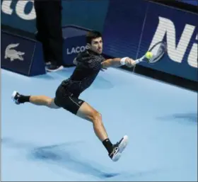  ?? ALASTAIR GRANT — THE ASSOCIATED PRESS ?? Novak Djokovic plays a return to Alexander Zverev during their ATP World Tour Finals match at the O2 arena in London, Wednesday.