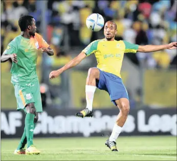  ?? PICTURE: BACKPAGEPI­X ?? Mamelodi Sundowns’ Tiyani Mabunda, right, is challenged by John Chingandu of Zesco during their CAF Champions League match at the Lucas Moripe Stadium in Pretoria on Saturday.