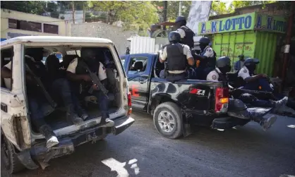  ?? Photograph: Odelyn Joseph/AP ?? Police patrol after recovering the bodies of two slain journalist­s in Port-au-Prince, Haiti, on Friday.