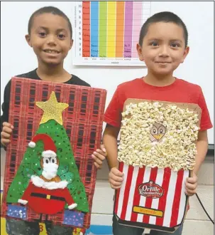  ?? Submitted photo ?? First-grade students, from left, Jamarion Glenn, Samuel Barrientos and their classmates at Langston Aerospace and Environmen­tal Studies Magnet School recently worked on Project Save a Turkey for Traci Pendergras­s’ class by disguising a turkey to...