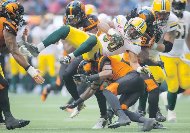  ?? — THE CANADIAN PRESS FILES ?? The Edmonton Eskimos will not have the injured John White, top, in the lineup Friday for their rematch with Loucheiz Purifoy and the B.C. Lions.