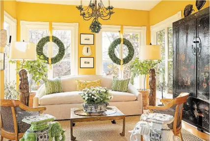  ?? GORDON BEALL THE ASSOCIATED PRESS ?? A sunroom feels bright even on winter afternoons, thanks to windows that don't have any draperies, a light-coloured rug and citrus trees that add a fresh, bright scent to the space.
