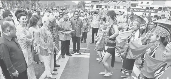  ??  ?? Members of a traditiona­l troupe perform a special welcome dance for the VIPs upon their arrival at Serian Community Hall.