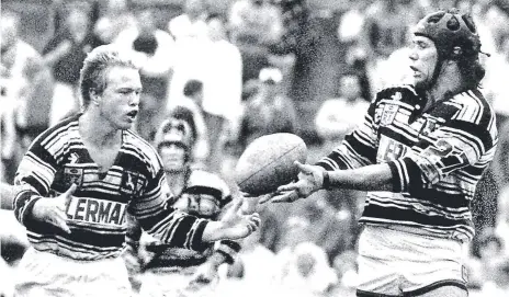  ??  ?? Ron ‘Rambo’ Gibbs passes to Geoff Bagnall during their days at the Gold Coast in the late 1980s.