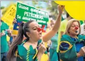  ?? Jefferson Bernardes
AFP/Getty Images ?? PROTESTERS RALLY against President Dilma Rousseff in Porto Alegre, Brazil, this week.