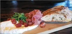  ?? PHOTO BY EMILY RYAN ?? Customers love this whipped ricotta board at Black Powder Tavern.