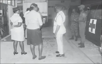  ??  ?? Deputy Commission­ers Paul Williams DSM (right) and Maxine Graham DSM (left), along with ranks from the Guyana Defence Force at the St. Joseph Mercy Hospital on Tuesday night, when the injured cop arrived.