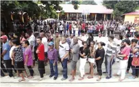  ??  ?? DILI: People queue up to give their vote during the presidenti­al election at a polling station. —AP