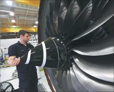  ?? CHRIS RATCLIFFE / BLOOMBERG VIA GETTY IMAGES ?? A technician checks the nose cone of a Trent XWB aircraft engine on the production line at the Rolls-Royce Holdings Plc factory in Derby, the United Kingdom.