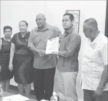  ??  ?? Managing Director of the Guyana Water Incorporat­ed Dr. Richard Van WestCharle­s (at centre) collecting the signed agreement from representa­tive of HiPro Ecologicos S.A de C.V Luis Fabela (second, from right) along with Chairperso­n of the Board of...