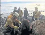  ?? MONTEREY COUNTY SHERIFF’S OFFICE ?? Emergency responders tend to Angela Hernandez after finding her in Big Sur on Friday. The 23-year-old Portland, Ore., resident went missing last week while driving to Southern California to visit family.