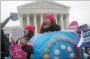  ?? CHARLES DHARAPAK — THE ASSOCIATED PRESS FILE ?? Margot Riphagen of New Orleans, wears a birth control pill costume as she protests in front of the Supreme Court in Washington in 2014.