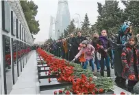  ?? Embassy of Azerbaijan ?? Azerbaijan­i citizens visit the Alley of Martyrs in Baku to pay tribute to those killed in “Black January.”