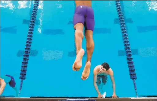  ?? Photograph­s by Christina House Los Angeles Times ?? ANTHONY RAMIREZ waits to exit the pool as another swimmer enters during the season-opening Kevin Perry Invitation­al in November.