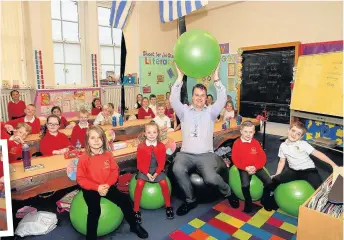  ??  ?? Tommy Taylor and his pupils having a great time in the class, above and left