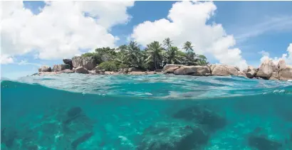  ?? Picture : AP ?? PROTECTED. A small island is seen above and below the water in the Seychelles. The tiny island nation of the Seychelles is announcing a pioneering marine conservati­on plan.