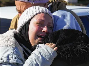  ?? HUSSEIN MALLA/ASSOCIATED PRESS ?? A woman mourns the loss of her mother, whose body was being transferre­d to Syria from a border crossing in Reyhanli, Turkey. Rescuers pulled more survivors from beneath the rubble of collapsed buildings on Thursday, but hopes of finding many more were fading.