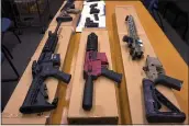  ?? HAVEN DALEY — THE ASSOCIATED PRESS, FILE ?? “Ghost guns” are displayed at the headquarte­rs of the San Francisco Police Department on Nov. 27, 2019. Families of those killed and wounded in a 2017 shooting are suing manufactur­ers and sellers of “ghost gun” kits.