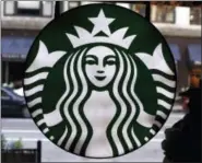  ?? AP PHOTO/GENE J. PUSKAR, FILE ?? Photo shows the Starbucks logo at one of the company’s coffee shops in downtown Chicago. Starbucks is pushing ahead with its expansion into China and said it is on track to having about 5,000 stores there by 2021, more than doubling the number of...